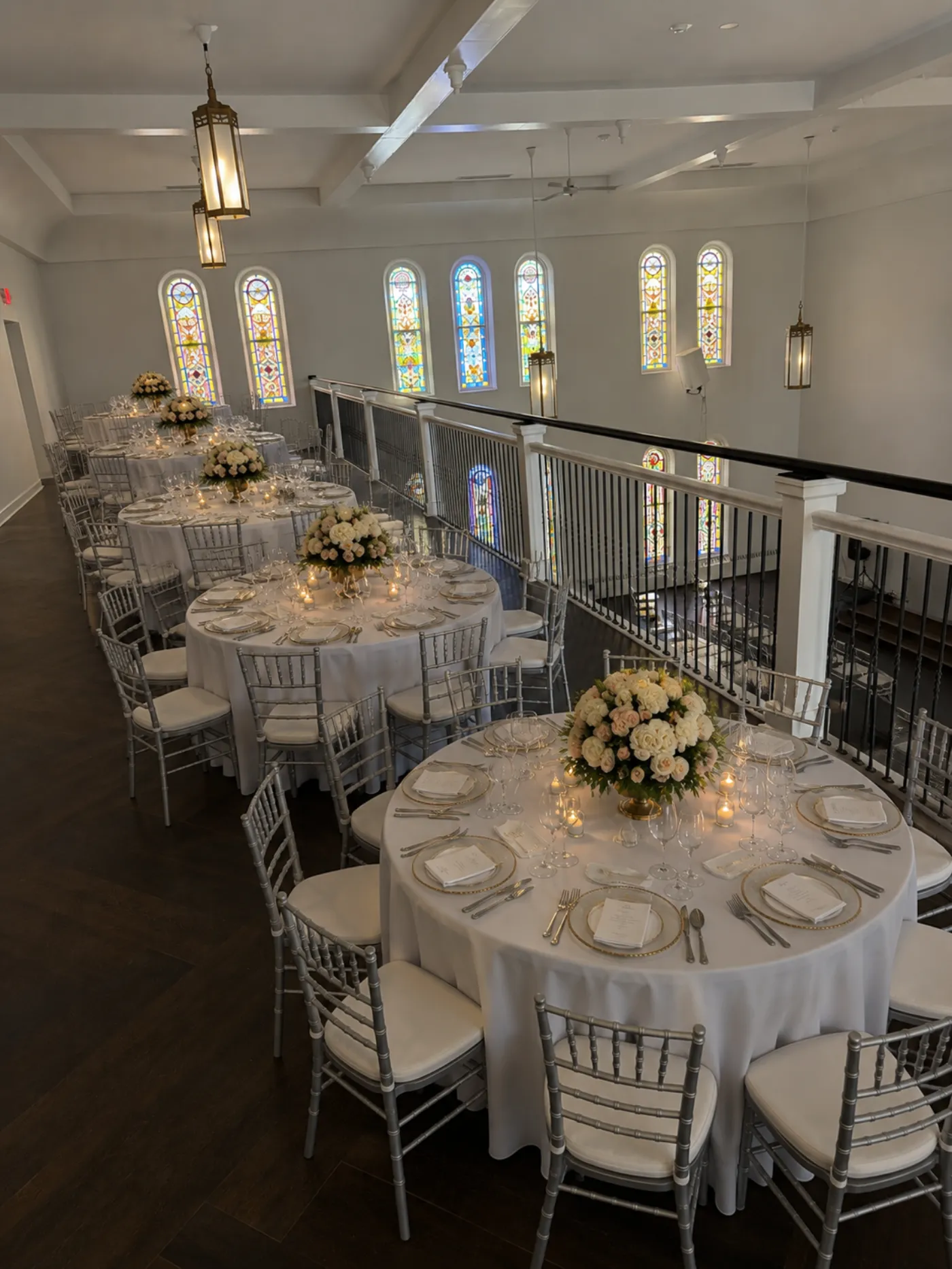 The balcony overlooking the main floor with tables and chairs